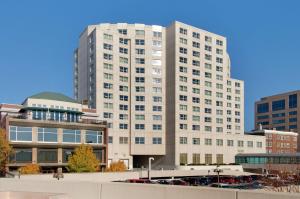 a large white building in a city with buildings at Hilton Madison Monona Terrace in Madison