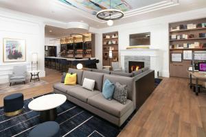 a living room with a couch and a fireplace at Hilton Madison Monona Terrace in Madison