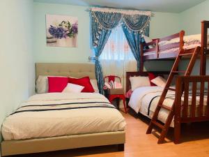 a bedroom with two bunk beds and a window at Four Seasons Private Villa in Powell River