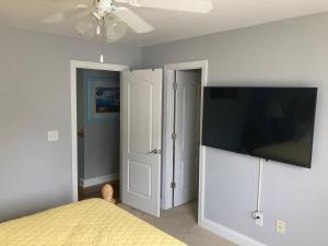 a bedroom with a bed and a flat screen tv at Casa Cool in Braselton