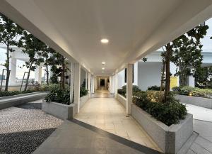 an empty hallway in a building with trees at Fiifo TenKinrara-Pavillion-IOI Mall-SunwayPyramid in Puchong