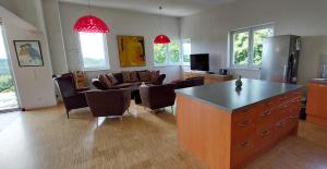 a kitchen and living room with a large island in a room at Villa Stressless in Köstenberg