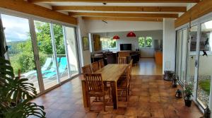 a kitchen and living room with a wooden table and chairs at Villa Stressless in Köstenberg