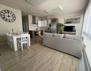 a living room with a couch and a table and a clock at Cal Xambu in Cambrils +29 photos