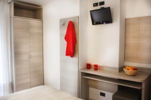 a bedroom with a fireplace and a tv on a wall at Hotel Daniela in Rimini