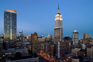 - une vue sur les toits de la ville avec un haut gratte-ciel dans l'établissement Hilton Garden Inn New York/Manhattan-Chelsea, à New York