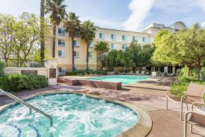 a swimming pool with a building in the background at Hilton Garden Inn Fairfield in Fairfield