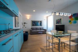 cocina y sala de estar con mesa y sofá en Blue Home Tellaro, en Tellaro