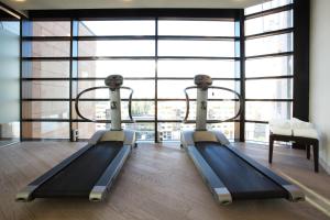 two beds in a room with a large window at Starhotels Grand Milan in Saronno