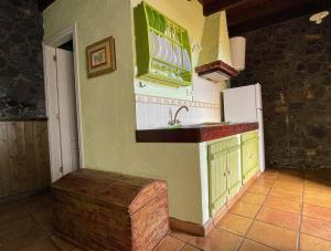 a kitchen with a sink and a refrigerator at Estudio Rural de Piedra in Frontera