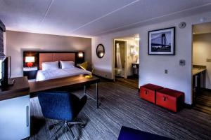 a hotel room with a bed and a desk at Hampton Inn & Suites Staten Island in Staten Island