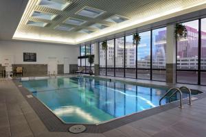 a large swimming pool in a building with windows at DoubleTree by Hilton Hotel & Executive Meeting Center Omaha-Downtown in Omaha