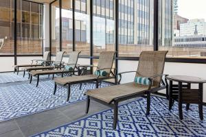 a row of chairs and tables in a room with windows at DoubleTree by Hilton Hotel & Executive Meeting Center Omaha-Downtown in Omaha