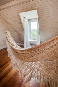 a hammock in a room with a window at Fairytale Loft Suite 1 bed, 1 bath Luxury Apartment in Downtown Belmont in Charlottesville