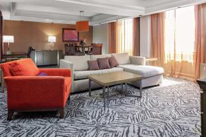 a living room with a couch and two chairs at DoubleTree by Hilton Hotel & Executive Meeting Center Omaha-Downtown in Omaha