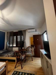 a bedroom with a bed and a table and chairs at Apartments Azra in Mostar