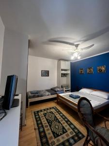 a room with two beds and a blue wall at Apartments Azra in Mostar