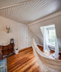a hammock in the corner of a room with a window at Fairytale Loft Suite 1 bed, 1 bath Luxury Apartment in Downtown Belmont in Charlottesville