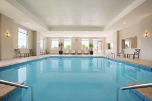 a pool with blue water in a hotel room at Embassy Suites Oklahoma City Downtown/Medical Center in Oklahoma City