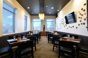 a dining room with tables and chairs and windows at Embassy Suites Oklahoma City Downtown/Medical Center in Oklahoma City