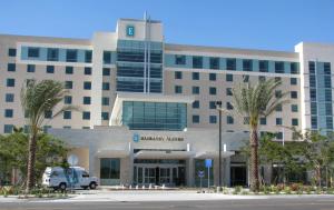 a building with a van parked in front of it at Embassy Suites Ontario - Airport in Ontario