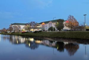 a body of water with buildings in the background at Hilton Garden Inn Chesapeake Greenbrier in Chesapeake