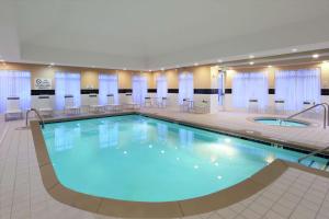 a large swimming pool in a hotel room at Hilton Garden Inn Chesapeake Greenbrier in Chesapeake