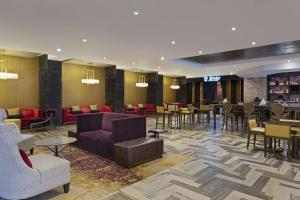 a lobby with couches and tables and chairs at DoubleTree by Hilton Orlando East - UCF Area in Orlando