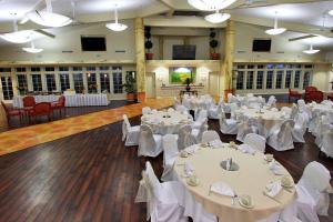 a banquet hall with white tables and chairs at Hilton Garden Inn Oxnard/Camarillo in Oxnard