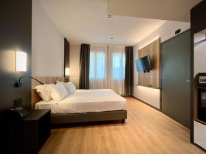 Postel nebo postele na pokoji v ubytování Hotel Leonessa