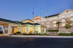 a hotel with two flags on top of it at Hilton Garden Inn Panama City in Panama City