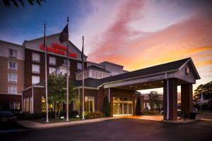 a hotel exterior with a american embassy inn at Hilton Garden Inn Hampton Coliseum Central in Hampton