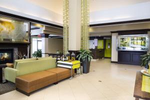 a lobby with a couch and a fireplace at Hilton Garden Inn Hampton Coliseum Central in Hampton