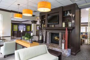 a living room with a fireplace and a couch at Hilton Garden Inn Hampton Coliseum Central in Hampton