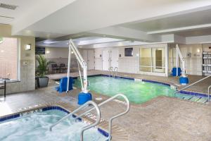 a large pool in a hotel with blue water at Hilton Garden Inn Hampton Coliseum Central in Hampton