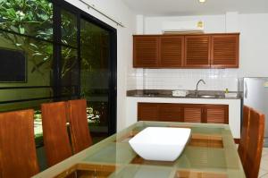 a kitchen with a table with a white bowl on it at Phuket Riviera Villas - SHA Extra Plus in Nai Harn Beach