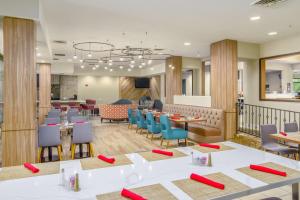 um restaurante com mesas e cadeiras e uma cafetaria em Hilton Garden Inn Phoenix Airport em Phoenix