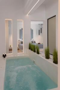 a room with a swimming pool in a house at Linea Luxury Suites in Fira