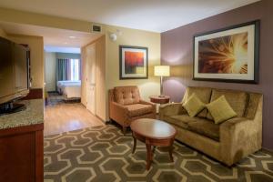 a living room with a couch and a room with a bed at Hilton Garden Inn Kennett Square in Kennett Square