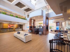 a lobby of a hospital with a couch and tables at Hilton Phoenix Airport in Phoenix
