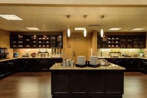 a large kitchen with black cabinets and a large island at Homewood Suites by Hilton Phoenix Chandler Fashion Center in Chandler