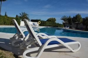 two lounge chairs sitting next to a swimming pool at Golfer Paradise next to La Quinta Golf Club RDR319 in Benahavís