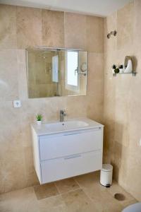 a bathroom with a white sink and a mirror at Golfer Paradise next to La Quinta Golf Club RDR319 in Benahavís