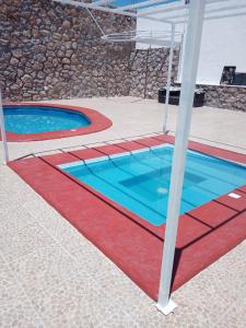 two swimming pools with red and blue at Casa del lago in Tequesquitengo