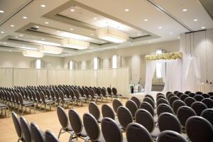 an empty banquet hall with chairs and a stage at DoubleTree By Hilton Baltimore North Pikesville in Pikesville