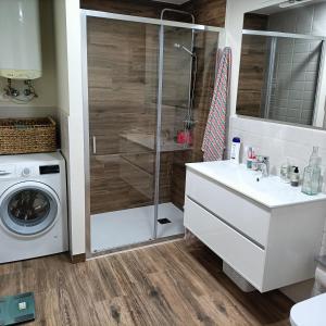 a bathroom with a shower and a washing machine at CASA TITA 