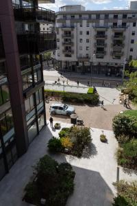 a car parked in a courtyard in front of a building at Clermont Hyper Centre & Parking in Clermont-Ferrand