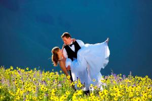 a man and woman dancing in a field of flowers at DoubleTree by Hilton Breckenridge in Breckenridge