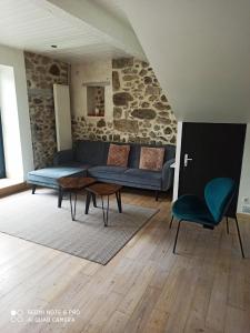 a living room with a couch and a table and chairs at Maison entière au Centre de Villeneuve d'Olmes in Villeneuve dʼOlmes