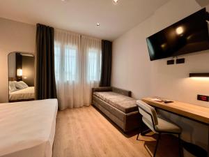Postel nebo postele na pokoji v ubytování Hotel Leonessa